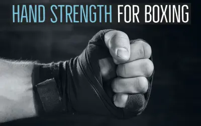 Close-up of a boxer's fist wrapped in tape, with text "HAND STRENGTH FOR BOXING" above. Learn how to strengthen wrists for boxing.