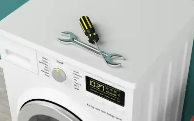 Outil de réparation sur un sèche-linge qui ne sèche plus. Le tournevis et la clé indiquent un problème.