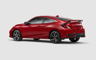 Czerwony Honda Civic Si coupe z czarnym spojlerem i felgami, gotowy do dynamicznej jazdy.