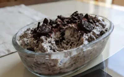 Pyszne lody oreo w szklanej misie, posypane pokruszonymi ciastkami i kakao. Idealne na deser!