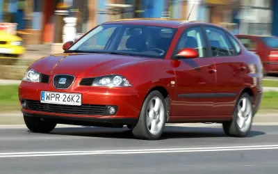 Czerwony Seat Cordoba 1.4 w ruchu ulicznym, z rozmytym tłem.