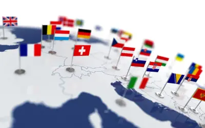 Mapa Europy z flagami państw. Zastanawiasz się, ile jest krajów w Europie? Ta wizualizacja pokazuje wiele z nich, od Wielkiej Brytanii po Bałkany.