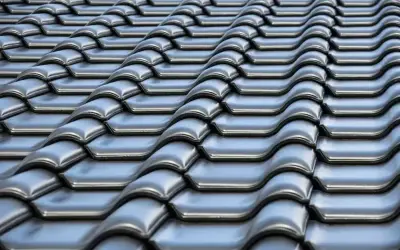 Szare dachówki ceramiczne tworzą falisty wzór na dachu. Ich waga zapewnia stabilność konstrukcji.
