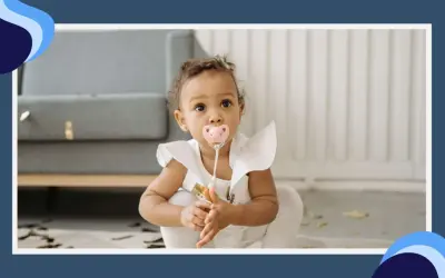 A baby girl with a pink pacifier in her mouth sits on the floor, her eyes wide with curiosity. The pacifier terth is a comforting presence as she explores her surroundings.