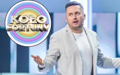 Norbi z Koła Fortuny w jasnej marynarce, z gestem dłoni, zastanawia się, dlaczego.