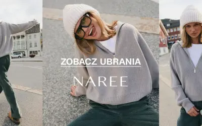 Kobieta w czapce i swetrze z wełny z merynosów, wesoło pozująca na tle ulicy.