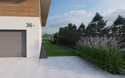 Piękne trawy ozdobne przy ogrodzeniu, obok nowoczesnego domu z garażem.