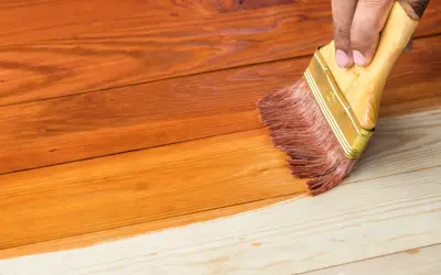 Aplicando barniz a madera de pino sin tratar, transformando su tono natural a un cálido color miel.