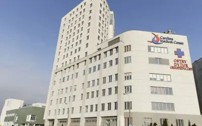 Nowoczesny budynek Carolina Medical Center w Warszawie z napisem "Ostry Dyżur Ortopedyczny".