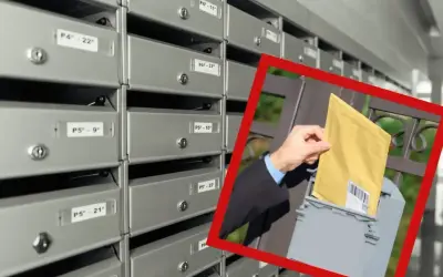 Rząd skrytek pocztowych. W kadrze dłoń wkłada żółtą kopertę do skrzynki. To może być awizo, co to jest?