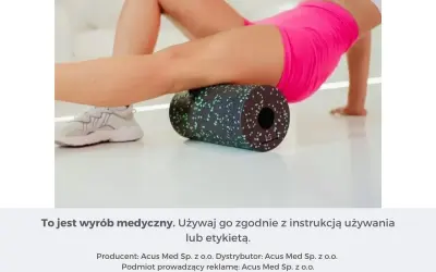 Kobieta wykonuje rolowanie mięśni ud na czarnym wałku z zielonymi kropkami, dbając o regenerację.