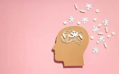 Symboliczne przedstawienie problemów z koncentracją i myśli w głowie, sugerujące poszukiwanie odpowiedzi na pytanie jak leczyć ADHD. Pigułki i puzzle symbolizują leczenie.