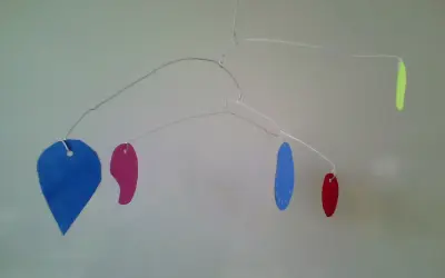 Mobile aux formes colorées, inspiré par Calder, parfait pour une chambre de maternelle.