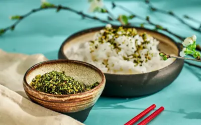 En skål med ris toppad med gröna kryddor, bredvid en skål med samma kryddblandning. Perfekt för ett umami recept.