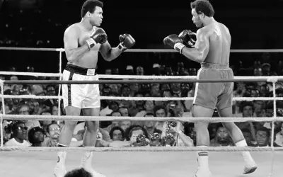 Muhammad Ali faces his opponent in the ring, a moment captured from one of his greatest fights.