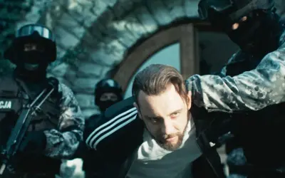 Policja zatrzymuje mężczyznę w dresie. Scena z filmu "Jak zostać gangsterem. Obsada" pokazuje brutalne starcie.