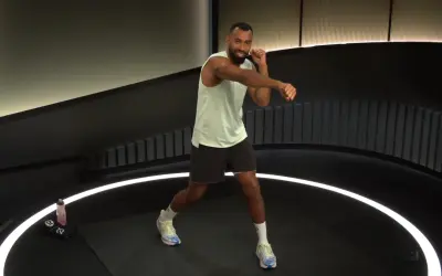 Man in athletic wear throws a powerful cross punch during a workout.