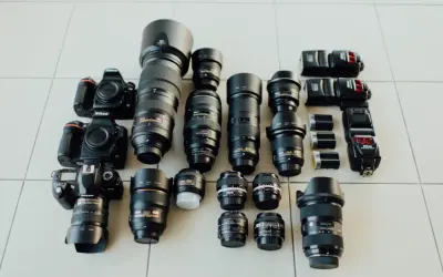 Nikon cameras and lenses laid out, a photographer's dream. Choosing the right camera depends on your needs, from portraits to landscapes.