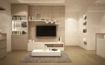 Nowoczesny salon z meblami w odcieniu waniliowy kolor, telewizorem i regałami pełnymi książek.
