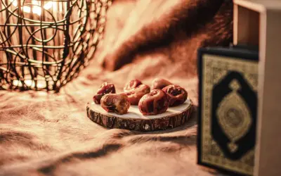 Datteln und ein Koran symbolisieren das Ende des Ramadan. So feiert man warum feiert man zuckerfest.