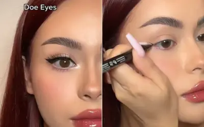 Kobieta z brązowymi włosami tworzy makijaż typu "doe eyes", podkreślając swoje duże, okrągłe oczy eyelinerem.