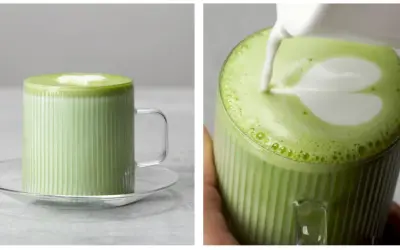 Zielone matcha z mlekiem w szklance z uchwytem, z pianką w kształcie serca.