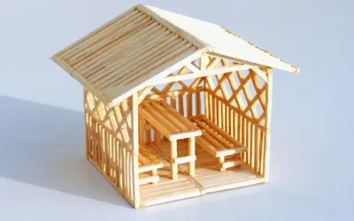 Miniaturowy domek z zapałek z ławkami i stołem. Inspiracja, jak zrobić domek z zapałek.