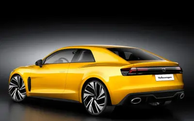 Żółty Volkswagen Corrado z nowoczesnym designem, sportowymi felgami i podwójnymi końcówkami wydechu.