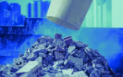 Cumulo di macerie e mattoni, residui di demolizione, con un tubo che scarica altro materiale.