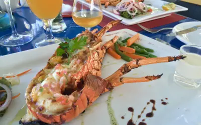 Wykwintne mauritius jedzenie: grillowany homar z warzywami i drinkami. Pyszny posiłek na wakacjach.