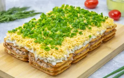 Warstwowa sałatka na krakersach z jajkiem, majonezem i szczypiorkiem. Pyszna przekąska na każdą okazję.