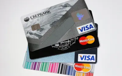 Pile di carte di credito e prepagate, tra cui Visa e Mastercard. L'IBAN è visibile su alcune carte.