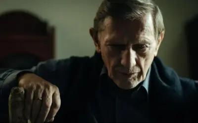 Jan Englert w filmach, zamyślony, z dłonią na lasce.
