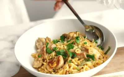 Szybki obiad z makaronem orzo i kurczakiem, posypany natką pietruszki. Idealny na szybki posiłek.