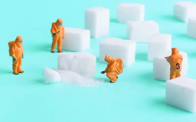 Figurki w pomarańczowych kombinezonach badają kostki cukru, jakby szukali jardiance skutki uboczne.