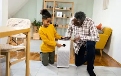 A boy and his grandfather learn how to test air quality in your home using a modern air purifier.