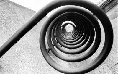 A spiral staircase, reminiscent of Edward Weston's famous photos, draws the eye inward.