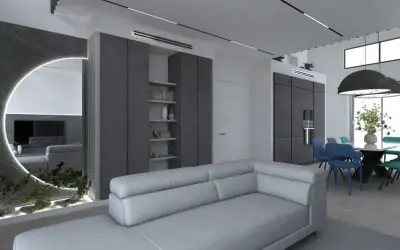 Un soggiorno moderno con divano grigio chiaro, pareti in vari tipi di grigio, specchio circolare illuminato e zona pranzo con sedie colorate.
