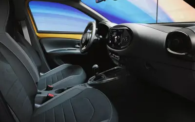 Wnętrze samochodu z nowoczesnymi fotelami i ekranem dotykowym. System keyless go ułatwia wsiadanie i ruszanie.