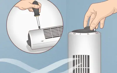 Démontez le ventilateur colonne avec un tournevis pour le nettoyer. Une main tourne le bouton de réglage.