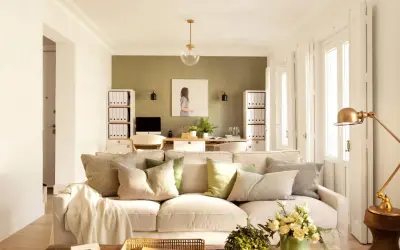 Ideas pintar salón en dos colores: pared verde texturizada y paredes blancas luminosas. Sofá beige, mesa de centro rústica, plantas y arte.