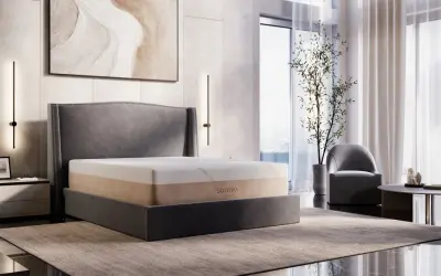 A Saatva memory foam mattress on a bed, showcasing its durability and comfort in a modern bedroom setting.