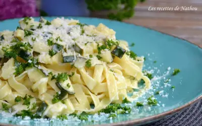 Assiette de tagliatelles de courgettes crémeuses, parsemées de persil frais et de parmesan râpé. Un délice léger et savoureux.