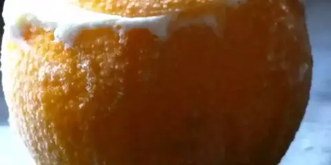 Une orange givrée, sa peau texturée recouverte de givre, promet une fraîcheur intense.
