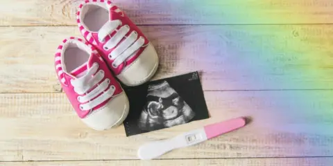 Ein positiver Schwangerschaftstest, ein Ultraschallbild und Babyschuhe. Ein Zeichen der Hoffnung nach einer Fehlgeburt, wieder schwanger.