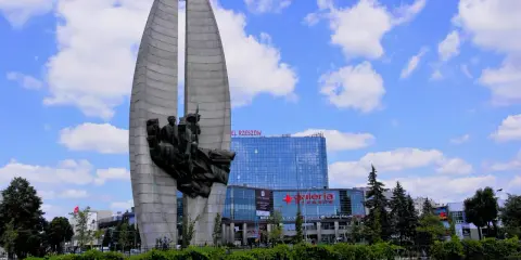 Pomnik Czynu Partyjnego, symbol Rzeszowa, na tle nowoczesnej Galerii Rzeszów.