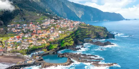 Buntes Dorf an steiler Küste Madeiras mit Terrassenfeldern und natürlichem Meerwasserpool. Tolle Madeira Info!