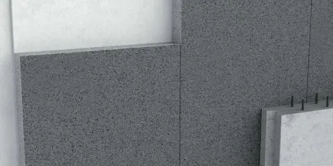 Detalle de un muro con hormigón aislante térmico, mostrando capas y textura granular.