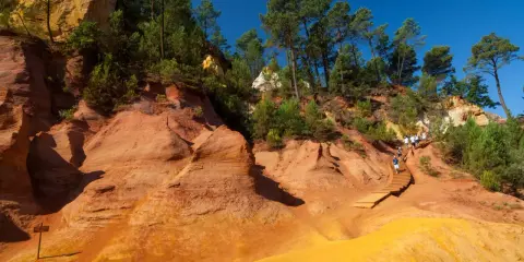 Sentier de randonnée à travers les ocres de Roussillon, où les formations rocheuses rappellent des cheminées de fée.