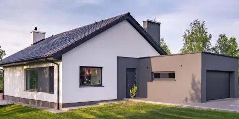 Nowoczesny dom z białymi i grafitowymi akcentami. Eleganckie kolory elewacji domu podkreślają jego architekturę.